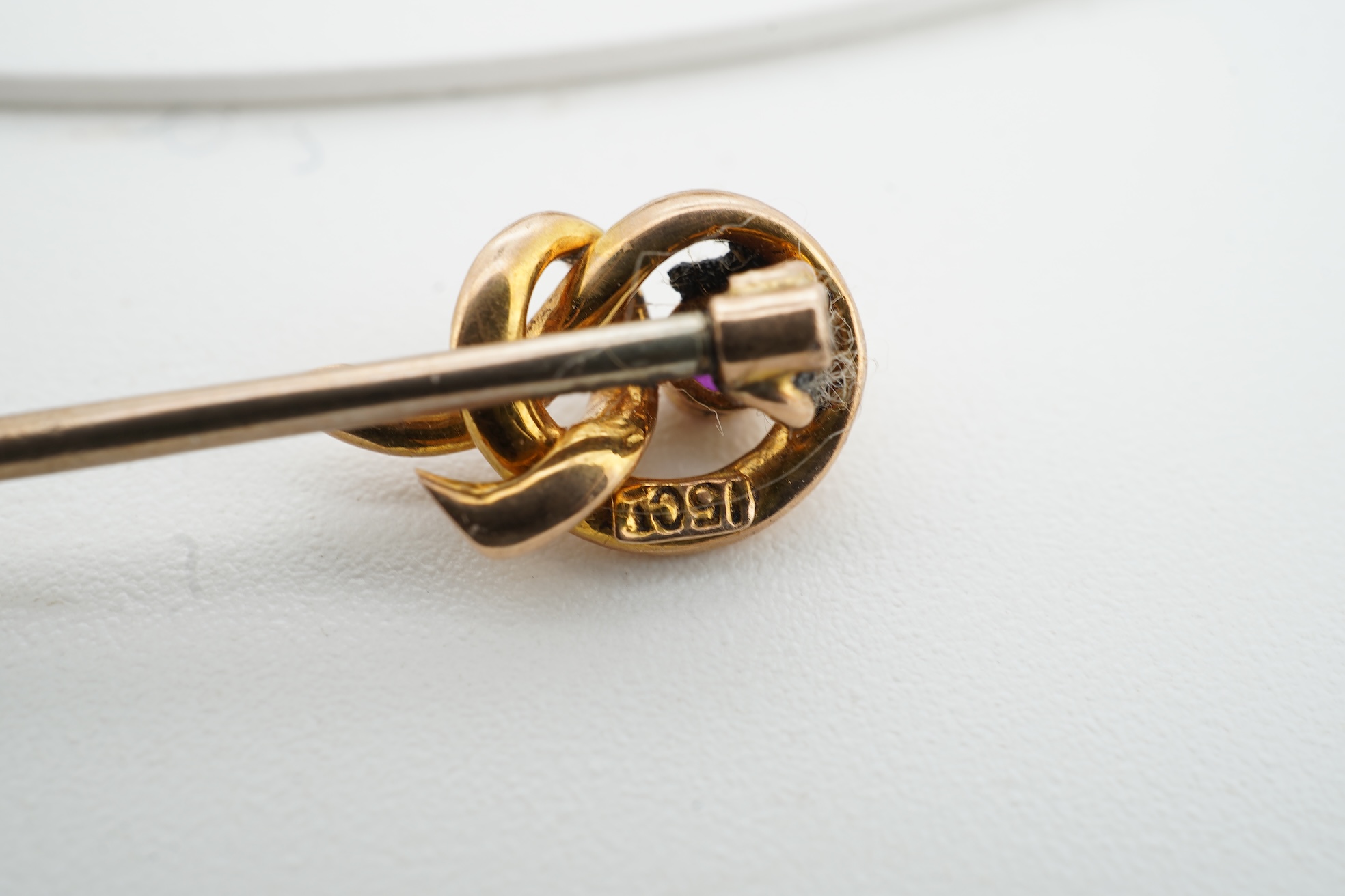 A collection of jewels, comprising: a stick pin, capped with the 'C' cipher with crowned ostrich feather and 'Ich Dien' motto for King Charles when Prince of Wales, in varicoloured gold and enamel, length 6.9cm, gross we